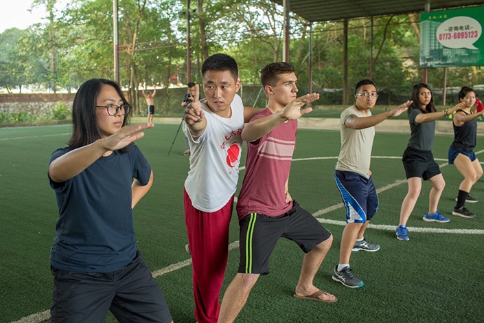 a row of students practicing tai chi