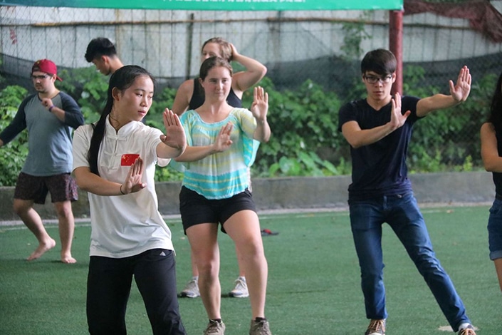 a group of CLI students and teachers practicing tai chi. 