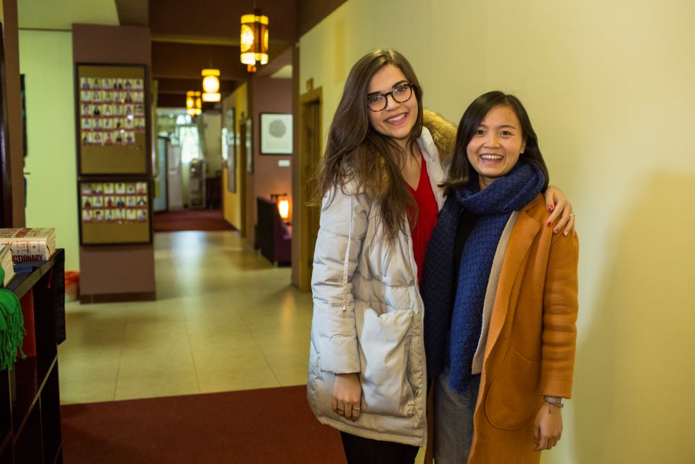 a student and teacher pose together inside the CLI center in China