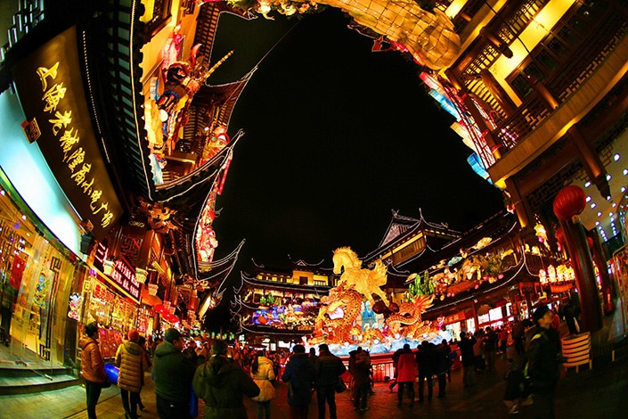 a photo of Chinese buildings and a Chinese Lantern Festival display at night