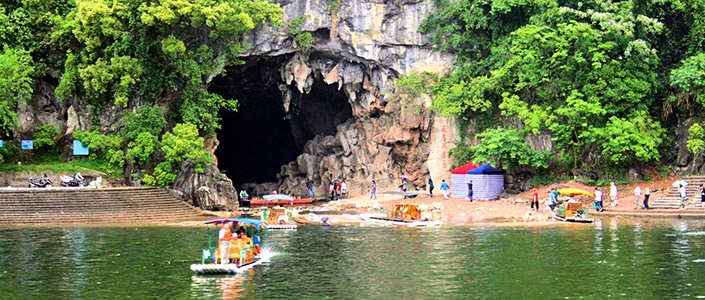 Yangshuo travel guides take travelers to visit a cave outside Yangshuo, China