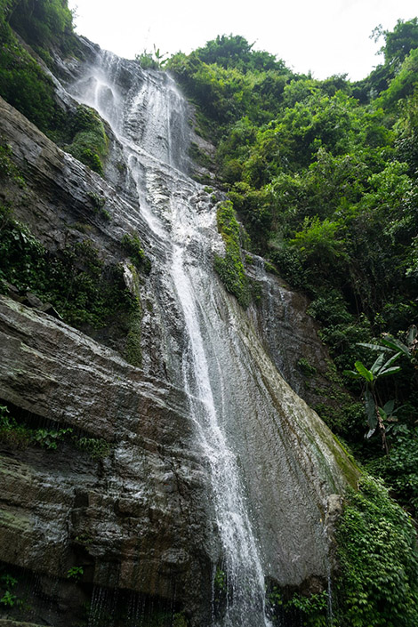 a waterfall pours over a cliff