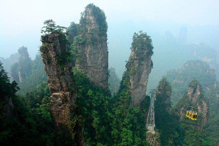 a yellow cable car and the peaks of Zhangjiajie, one of the best places to visit in China