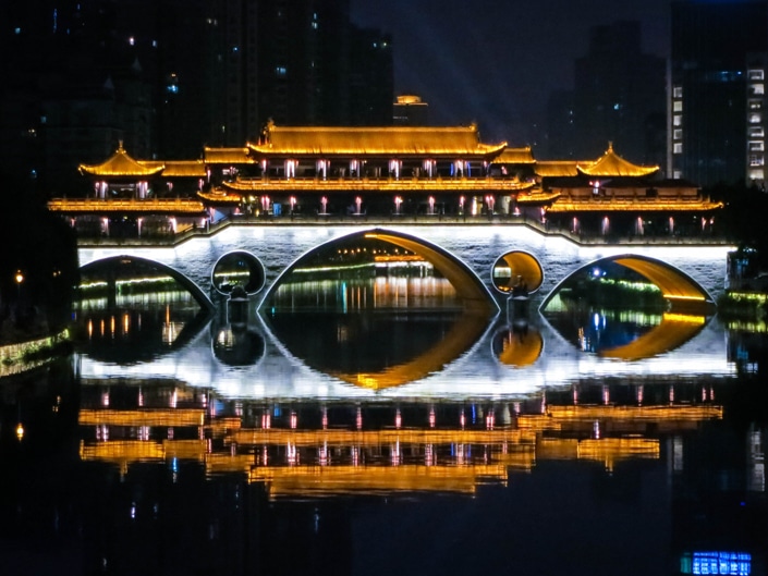 a bridge with lights at night in Chengdu, one of the best places to visit in China