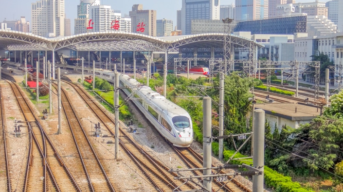a Chinese train leaving Shanghai Railway Station