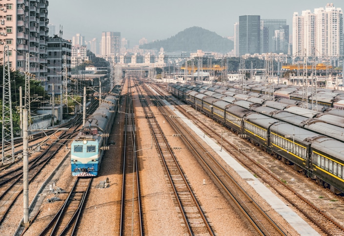 old-fashioned Chinese trains sit in a railyard