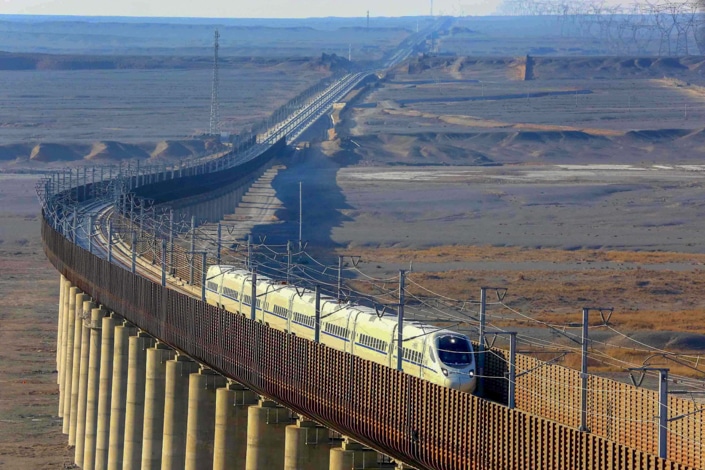 a Chinese train traveling through a desolate landscape