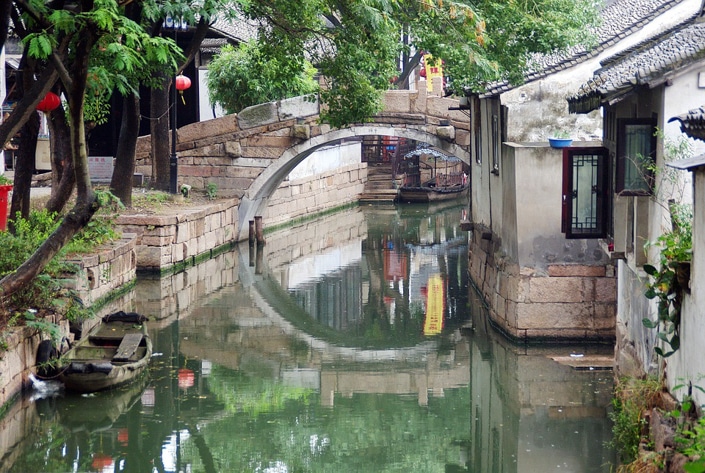 an ancient bridge popular with Suzhou travel guides over a canal in Suzhou