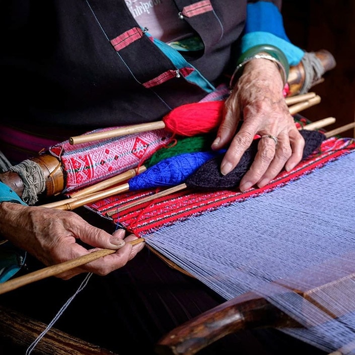 an old woman weaving Chinese Zhuang minority group brocade