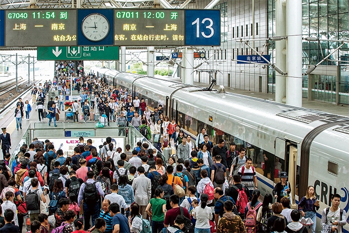 a train platform in Nanjing, China packed with crowds of people during the holiday travel period