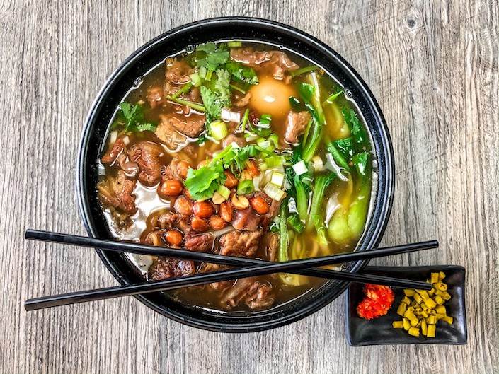 a bowl of Guilin rice noodles with a pair of chopsticks