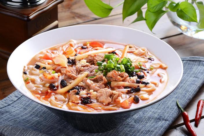 a bowl of Guilin rice noodles with pickled black beans and pork