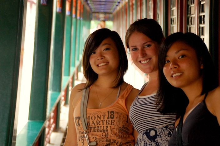 a group of three CLI students posing in the Long Corridor in the Summer Palace