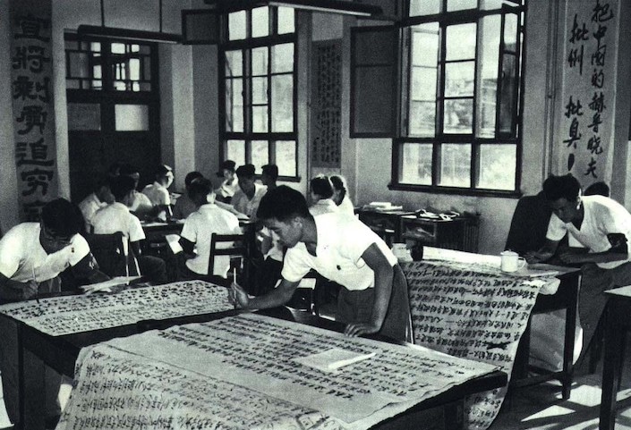 a black and white photograph showing Chinese university students writing big character posters during the Cultural Revolution