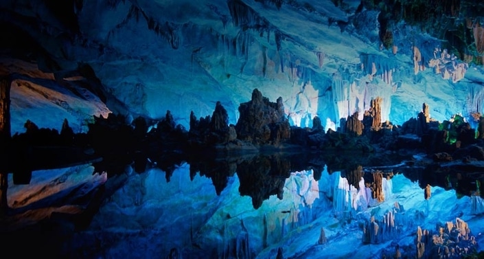 a view of rock formations illuminated with blue light in Seven Star Cave