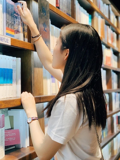 chinese girl browsing books at library