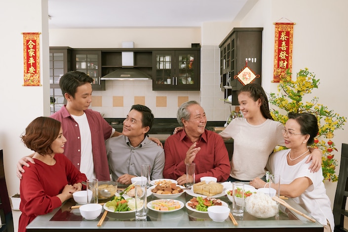 Chinese family gathered around the dining room table at home